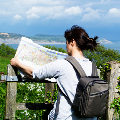 A small business owner looking at a map in the countryside