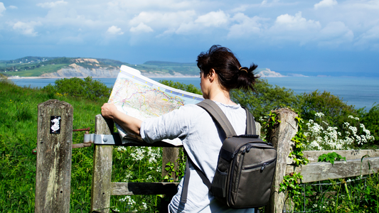 A small business owner looking at a map in the countryside